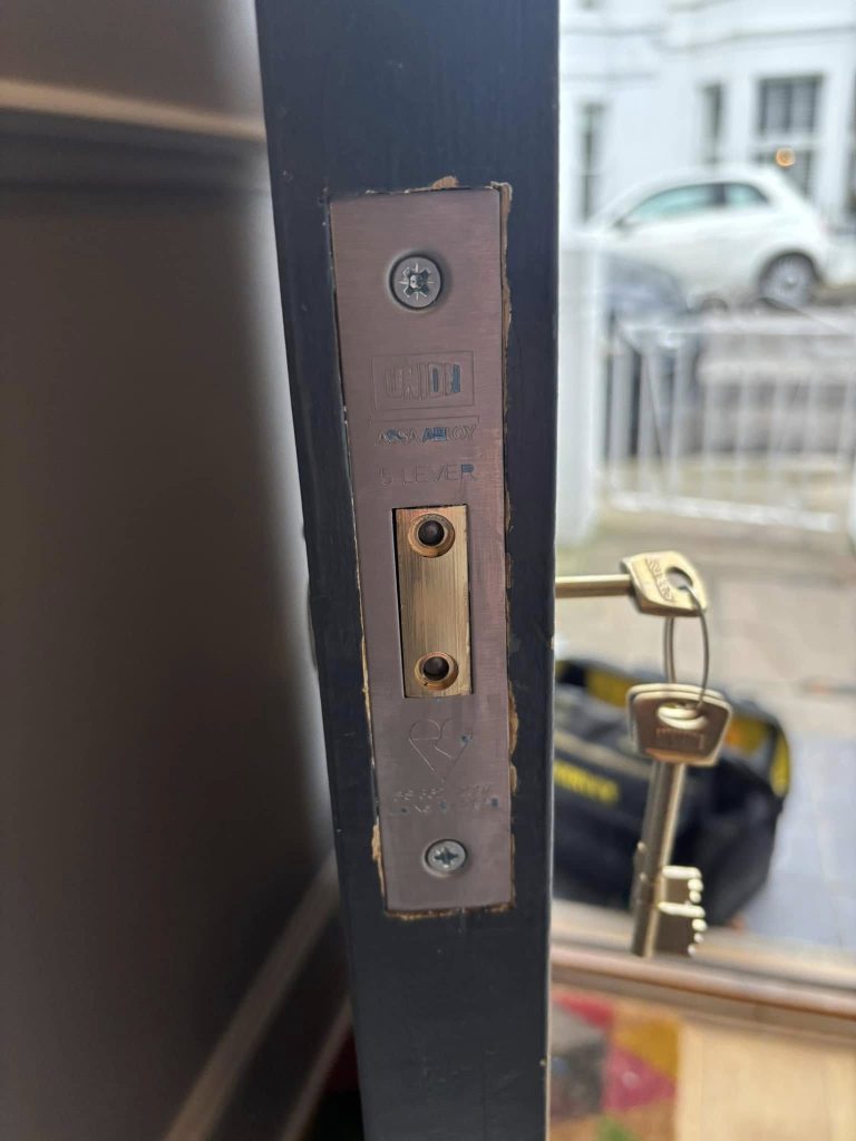 An image of the lock installed on the door with the key in