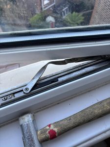 The buckled hinge in a UPVC window